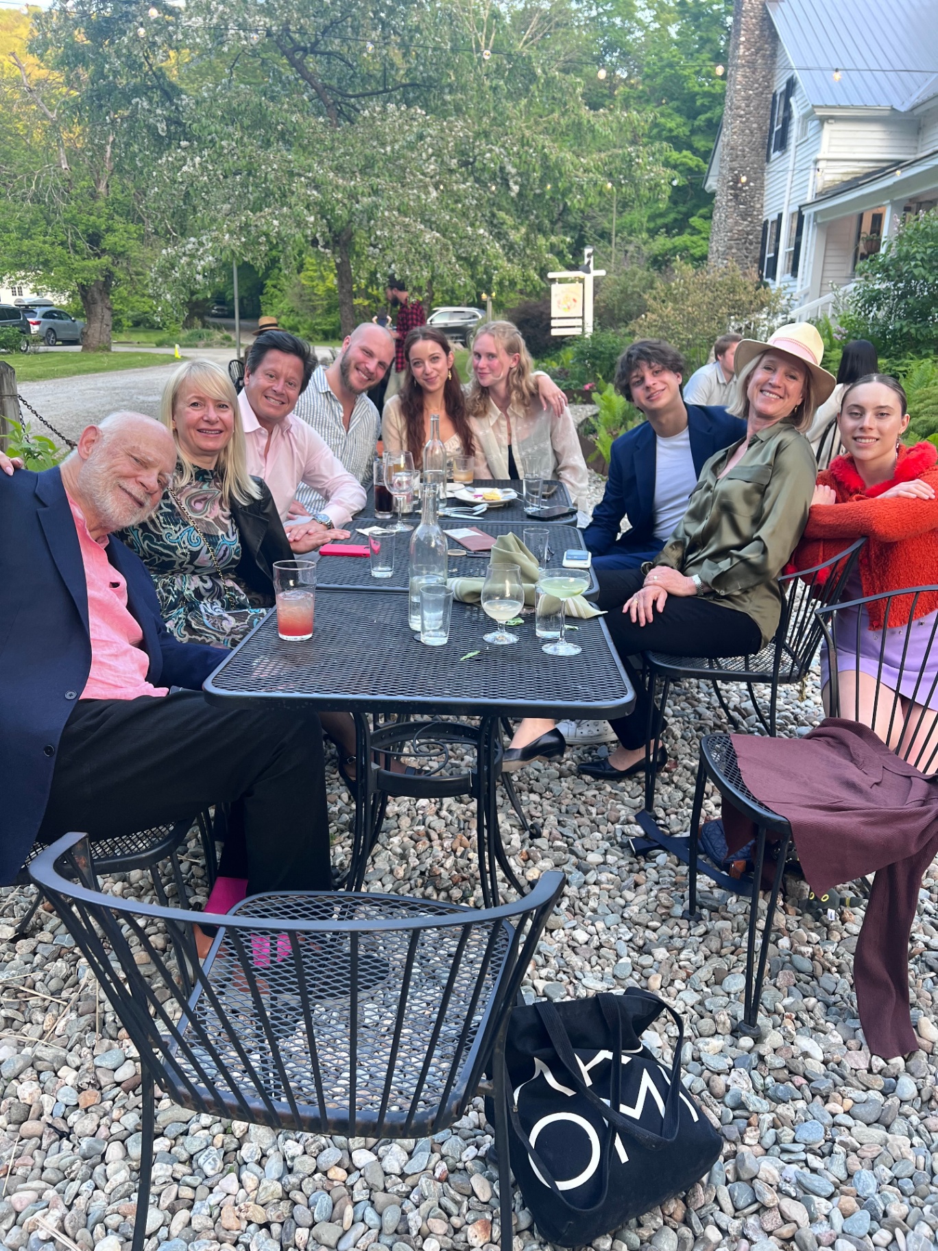 Noa and family gathered around an outdoor dinner table