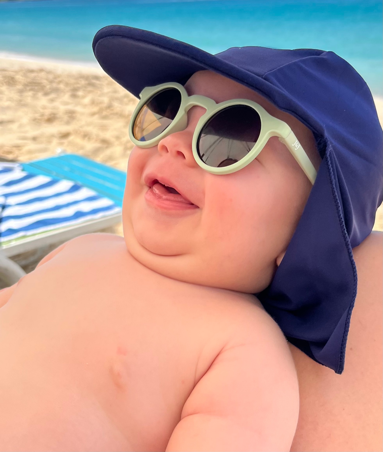 Oren in sunglasses and a sun hat on the beach
