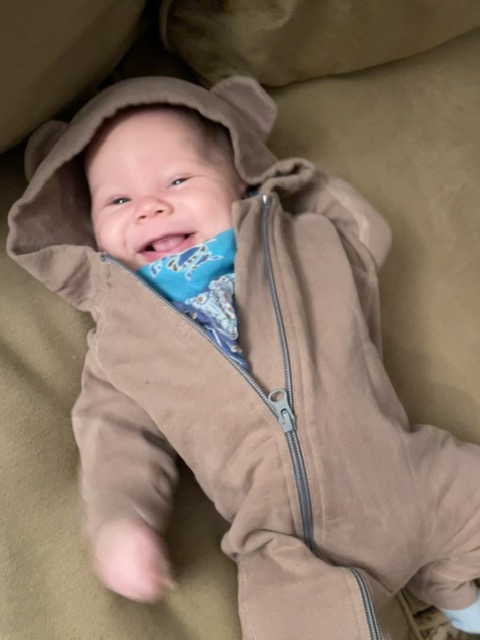 Oren in a bear suit, grinning