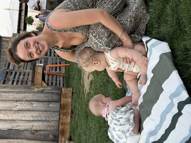 Noa with Oren and a friend on a picnic blanket